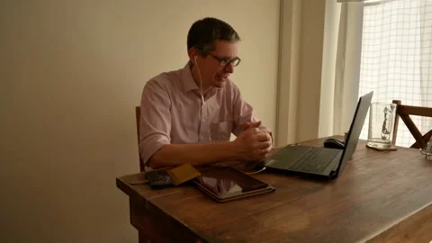 Timelapse of middle aged man participating in a meeting over video conference Stock Footage 136864496