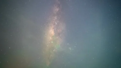 Timelapse of Milky Way across deep blue night sky with scattered clouds and Stock-Footage 320163574