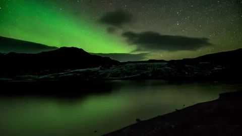Timelapse of milky way and northern lights moving over glacier and lagoon Stock Footage 73011663