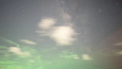 Timelapse of the Milky Way with drifting clouds and green light from fishing 스톡 동영상 317937853