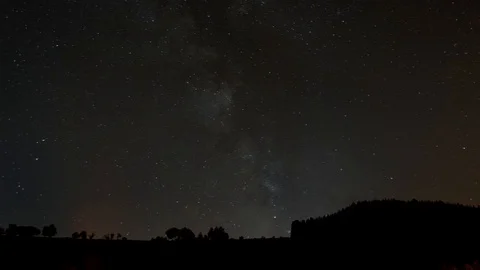 TImelapse of Milky Way in German Eifel behind mountain silhouette and many ai Stock Footage 97663767
