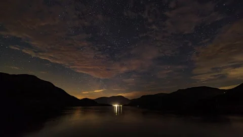 A timelapse of the Milky way peaking through clouds over Ullswater in the E.. Stock Footage 284013305