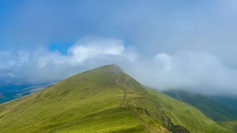Timelapse mist dissipates over the top of the mountain Stock Footage 205658191