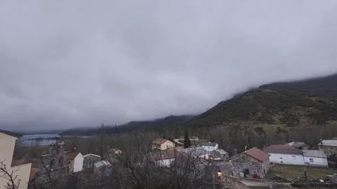Timelapse of the mist moving at sunrise in a small mountain town in palencia, Stock Footage 125603242