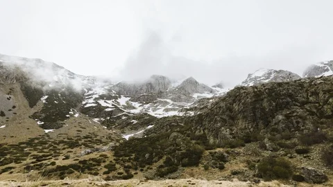 Timelapse of the mist wrapping the espigete mountain in a windy and cloudy wi Stock Footage 125607467