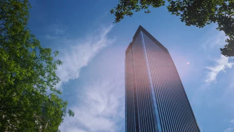 Timelapse modern skyscraper high office building and green trees on sunny day Video stock 200881517