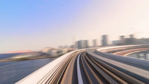 Timelapse of Monorail train speed through Rainbow Bridge in morning sunrise  Stock Footage 196476048