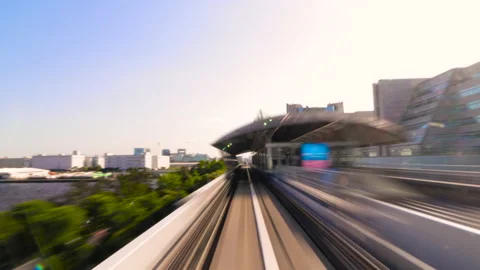 Timelapse of Monorail train travel between stop in Odaiba, Tokyo during sunrise Stock-Footage 196476388
