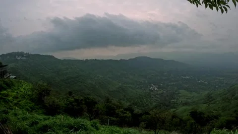 Timelapse of monsoon clouds drifting over green mountains from day to night in 스톡 동영상 311805193