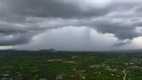 Timelapse of monsoon clouds forming over green valley with road and small Stock Footage 312538635