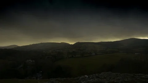 Timelapse of moody clouds coming in over hillside Stock Footage 114064358