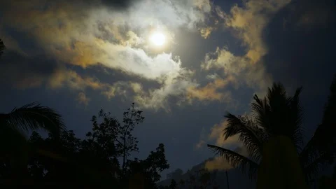 Timelapse of moon light shining through clouds on tropical beach Stock Footage 124997329