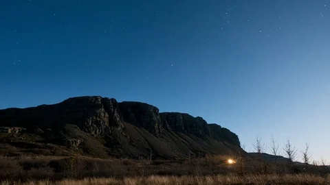Timelapse of moon lit cliff with a starrie background Video stock 85482876