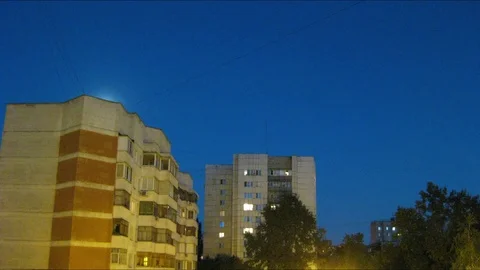 Timelapse of the Moon over a dormitory district Stock Footage 106701885