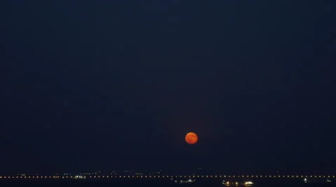Timelapse the Moon Rises From the Horizon Over City Lights Stock Footage 67592527