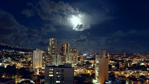 Timelapse of a moon rising up over a city in Honolulu Hawaii Stock Footage 78557680