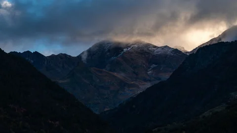 Timelapse of morning light going through Pyrenees peaks, low clouds with colourf Stock Footage 164726848