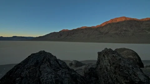 A timelapse of morning shadows receding over the Racetrack Playa in Death Val Stock Footage