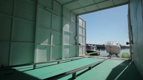Timelapse of motor boat going witnin garage 库存影片 61272744