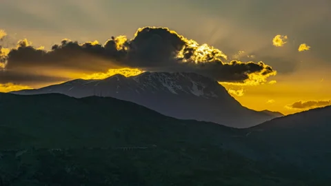 Timelapse of a mountain landscape at sunset with clouds Stock Footage 154677295