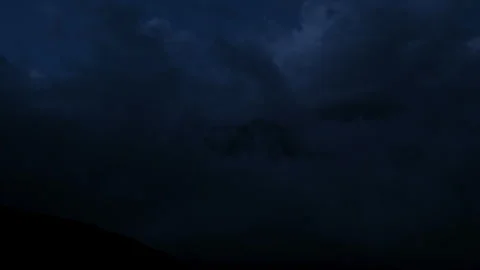 Timelapse of mountain peak covered with clouds at night Video stock 254763303