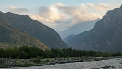 Timelapse of mountain river flowing in gorge on background of sky with clouds Stock Footage 292306656
