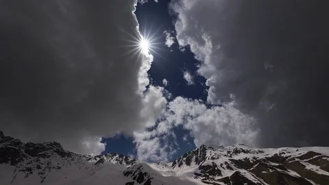 Timelapse of the mountains and clouds. the sun behind the clouds Stock Footage 114256690