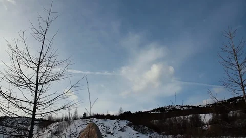 Timelapse in mountains, mountains in winter, clouds sweep over, sunny weather Stock Footage 128977693