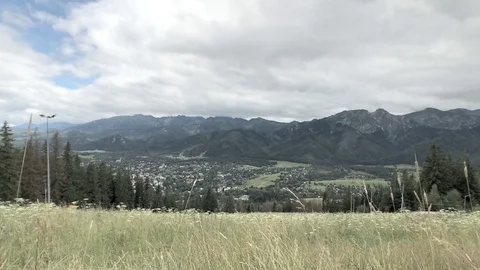 Timelapse of mountains with a small town in the valley Stock Footage 82623130