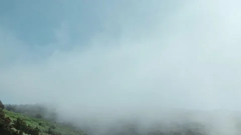Timelapse of the movement of clouds over mountains covered with green vegetation Stock Footage 135417838
