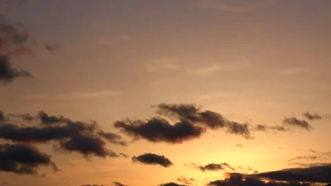Timelapse of the movement of clouds at sunset. Golden sky at magic hour. 4K Stock Footage 313705223