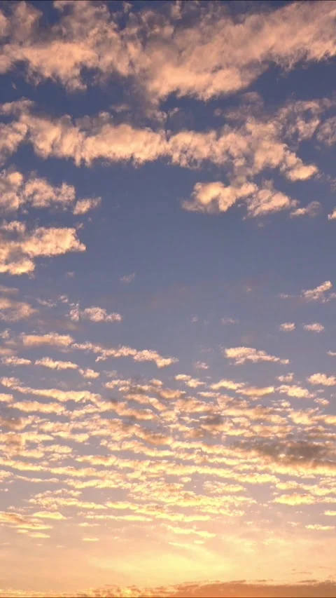Timelapse of the movement of clouds at sunset. Golden sky at magic hour. 4K Stock Footage 337932772
