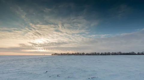 Timelapse. The movement of the clouds at sunset in the snowy steppe in winter. Stock Footage 61121661