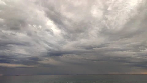 Timelapse. Movement of large dark rain clouds and rain on horizon over surface Stock Footage 212935287