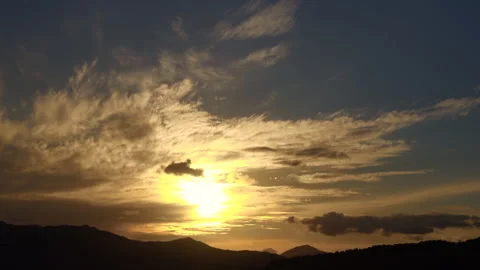 Timelapse of the movement of the sun and clouds at sunset. Autumn golden sky. 4K Stock Footage 303531563