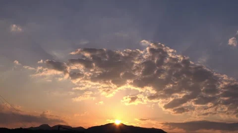 Timelapse of the movement of the sun and clouds at sunset. Golden sky. 4K Stock Footage 336038091