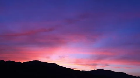Timelapse of the movement of the sun and clouds at sunset. Blue and red sky. 4K Stock Footage 336939063