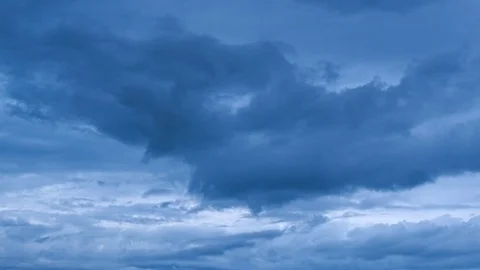 Timelapse of moving and changing dark gloomy blue clouds Stock Footage 80130390