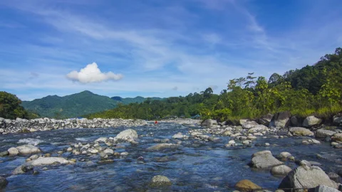 Timelapse of moving cloud and riverat Kota Belud, Sabah Stock Footage 200860564