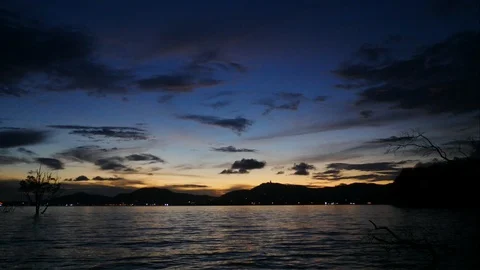 Timelapse of moving cloud and sea wave with mountain and silhouette mangrove  Video stock 99617519
