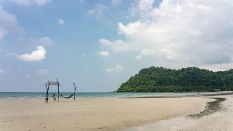 Timelapse of moving clouds above beautiful white sand beach at Koh Kood Stock Footage 272613344