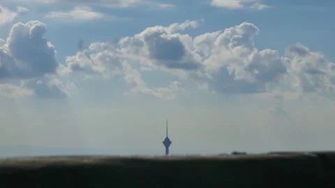 Timelapse of moving clouds above city tower skyline Stock Footage 318922041