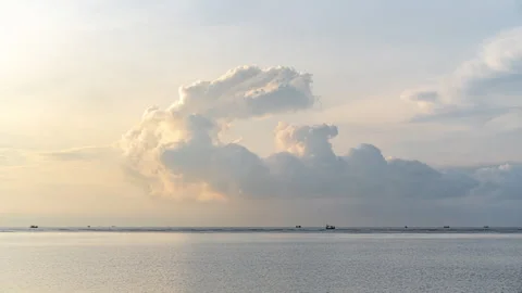 Timelapse of moving clouds during morning sunrise over the ocean Stock Footage 309076295