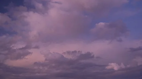 Timelapse of moving clouds at dusk with stars appearing in a blue sky. Stock Footage 129673230