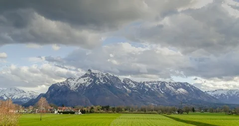 Timelapse of moving clouds with mountains and green meadows in the Alps Stock Footage 88479480