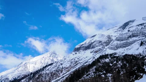 Timelapse of moving clouds over mountain with snow at hintertux glacier in .. Stock Footage 283553137