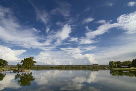 Timelapse of moving clouds reflecing off Inks Lake, Texas Stock Footage 96201645