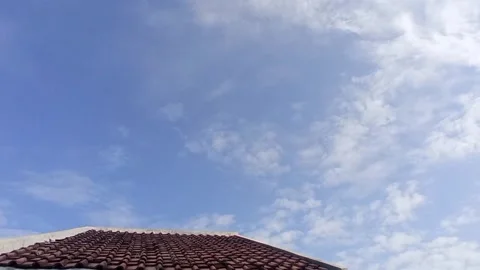 Timelapse: Moving clouds on the roof Stock Footage 243553719