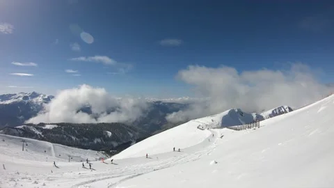 Timelapse of moving clouds in snow-capped mountains Stock Footage 159753690