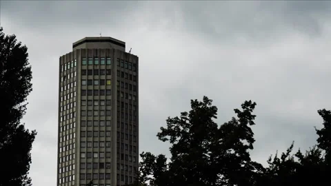 Timelapse of moving clouds with special building and trees on a rainy day Stock Footage 250082113